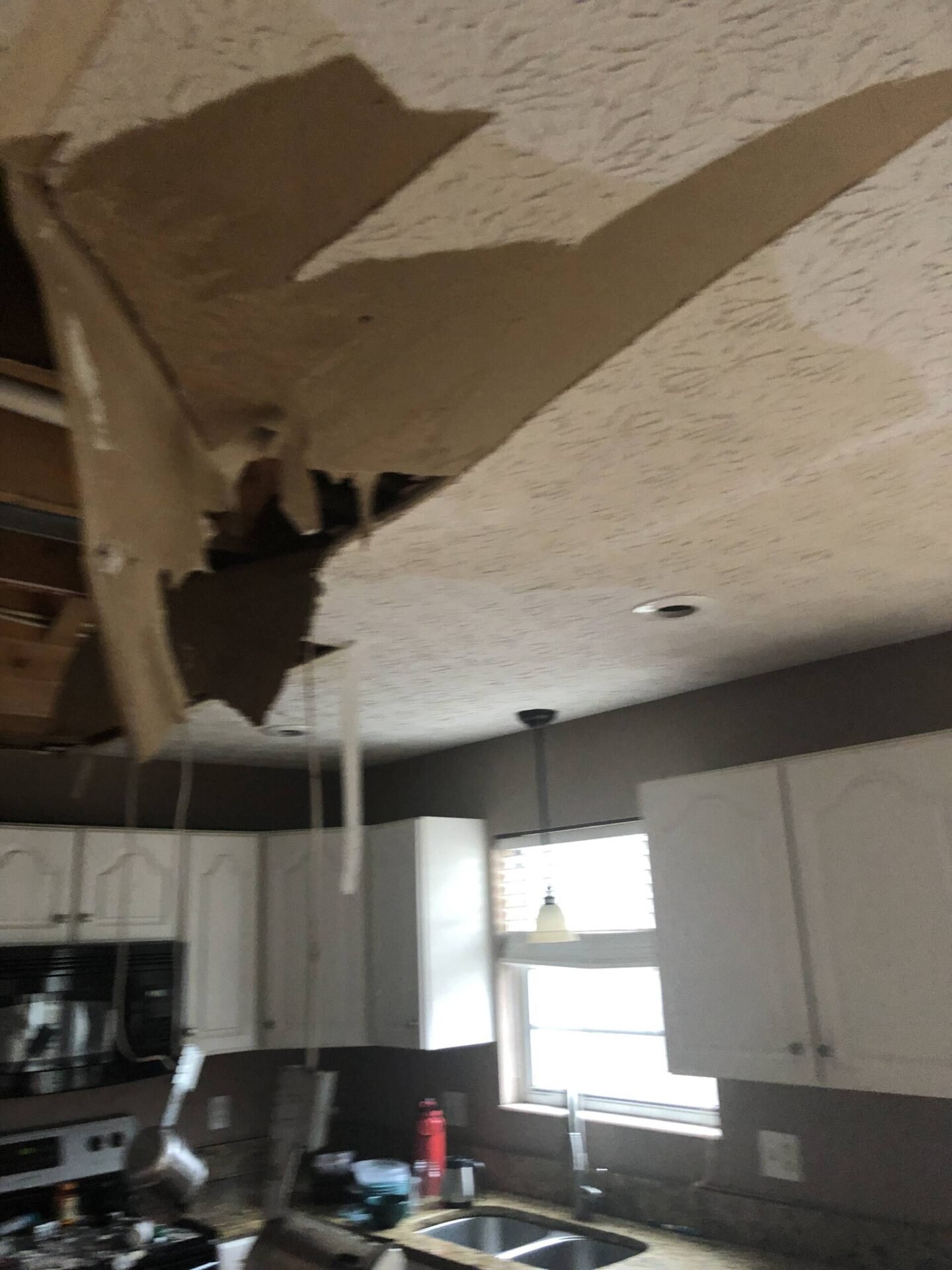 Water-damaged ceiling material above a kitchen