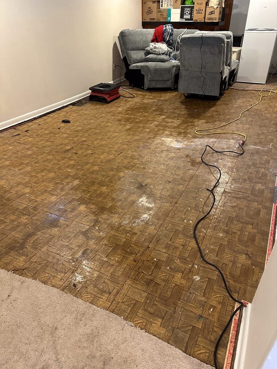 Air mover and affected parquet flooring in an indoor room